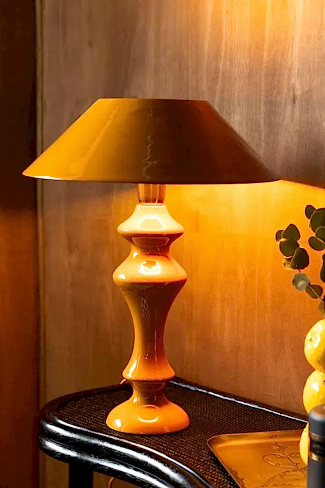 Mustrad yellow lamp on a table ledge