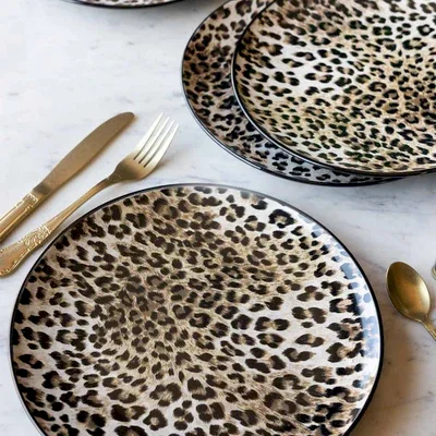 Various leopard print plates styled together with some cutlery.