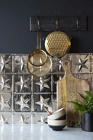 A close up image of Rockett St George tin tile in a star shape design in a kitchen scene.