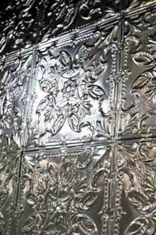 Close up image of silver Rockett St George tin tiles in a floral pattern.