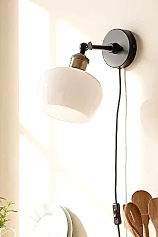 Image of the Beautiful Glass Plug In Wall Light in a white kitchen.