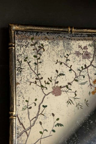Close-up of the top left-hand corner of a rectangular mirror - the Beautiful Pink Chinoiserie Decorative Mirrored wall art.