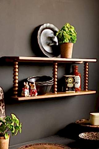 The Dark Wood Bobbin 2-Tier Wall Shelf styled in a kitchen with plates, plants and accessories.