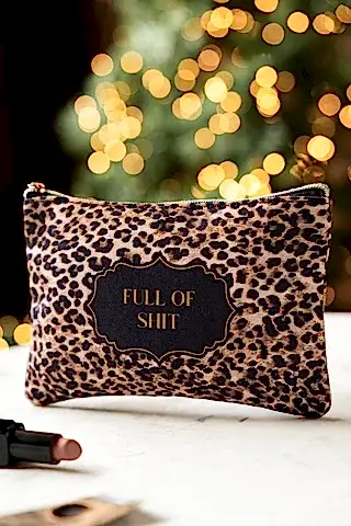 Full of Shit Leopard Print Canvas Pouch shown on a marble surface with a lipstick.