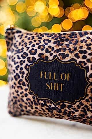 The side detail of the Full of Shit Leopard Print Canvas Pouch. 