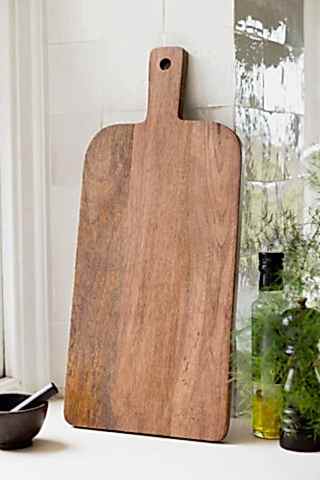 Back of the Leopard Print Tall Wooden Serving Board, shown against white zellige kitchen tiles. 