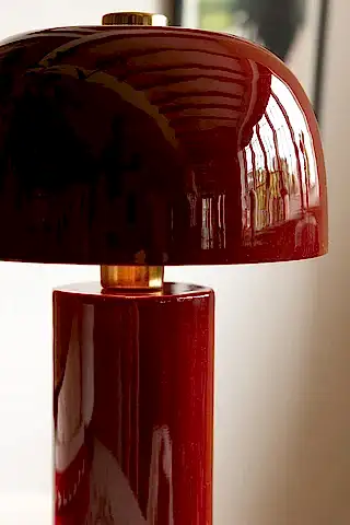Extreme close-up of glossy burgundy table lamp