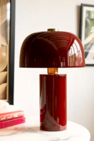 Close up of deep red, glossy table lamp
