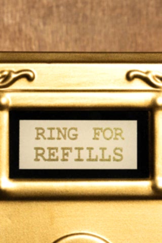 The text on the Ring For Refills Gold Wall Ornament. 