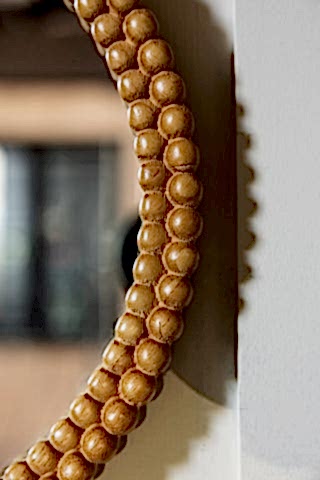The side of the Round Bobbin Frame Mirror, showing the bobbin detailing. 