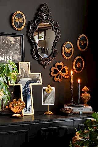 A glamorous, gothic scene with the Set of 4 Black & Gold Entomology Wall Art styled amongst a black ornate mirror and other gold milagro details.