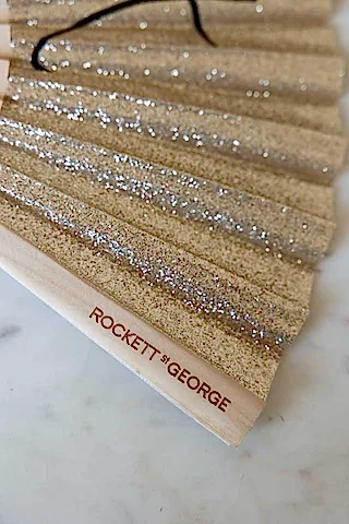 Detail shot of the Shit Hot Black & Gold Glitter Fan.