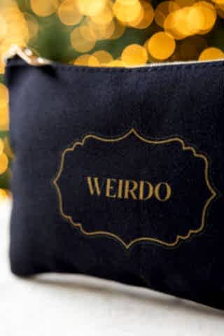Close up detail of the text on the Weirdo Black Canvas Pouch. 