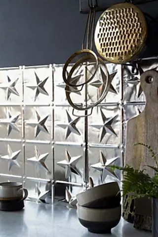 Close up image of a Rockett St George star Tin tile in a kitchen setting.
