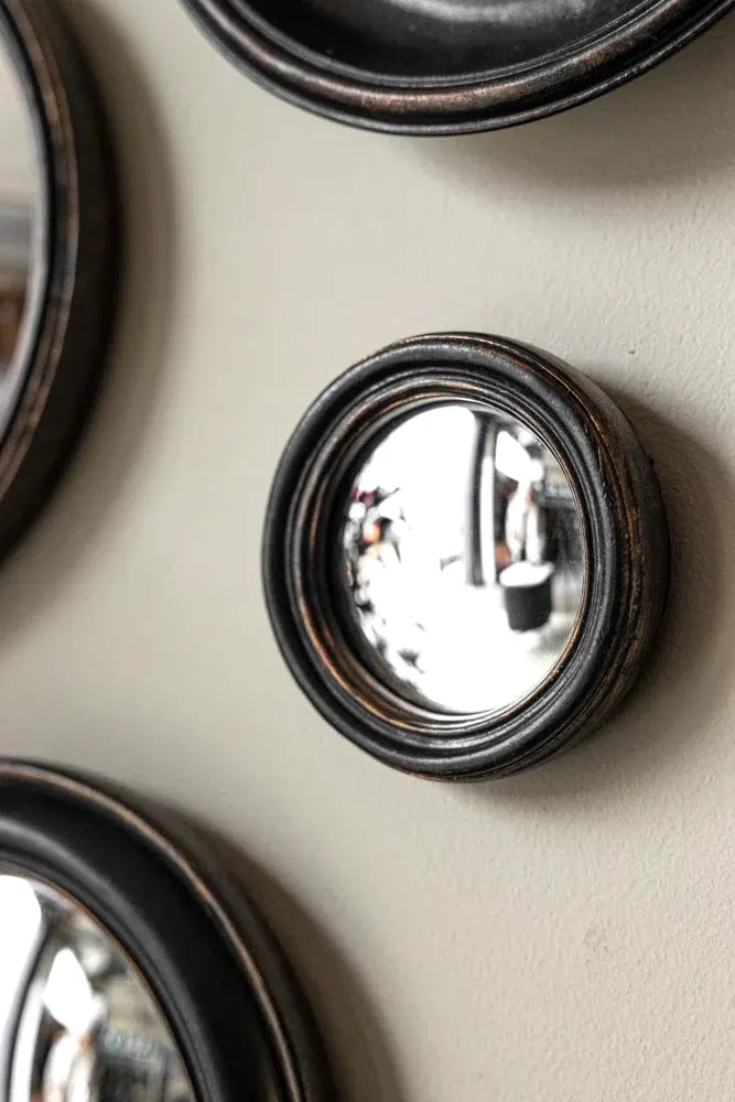 Lifestyle image of the Antique Black Thin Framed Extra Small Convex Mirror