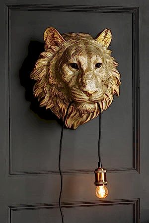 Angled image of the Lion Head Wall Light with the light on
